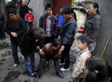 A relative of a miner grieves near the state-run Pingyu Coal & Electric Co. Ltd mine in Yuzhou city, central China's Henan province on Sunday.