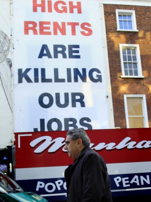 Ajai Chopra from the IMF passes a placard on his way to the Central Bank on Thursday.