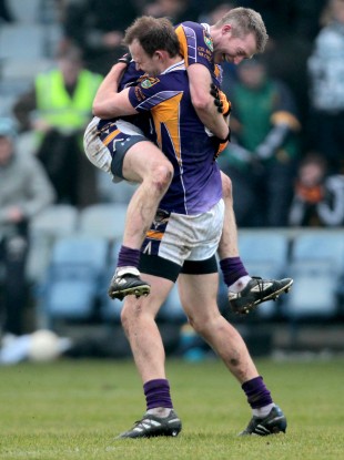 Crokes' Liam Og O Heineachain and Paddy Duggan celebrate at the final whistle.