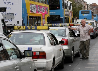 A taxi driver waits by his parked taxi on O'Connell Street, Dublin, during the protest by taxi drivers protesting over the current economic conditions in the industry in 2009.