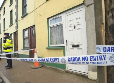 A garda stands outside the house at Ballybay, Co Monaghan, yesterday.