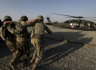 A soldier is helped onto a US Army medical evacuation helicopter in Southern Afghanistan.