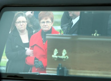 Anne Connolly (2nd left), sister of Peter Wilson, with her daughter Francis (left) watch a coffin with remains of a body, believed to be that of the ninth so-called Disappeared victim Peter Wilson, being removed from Waterfoot beach in the Glens of Antrim.