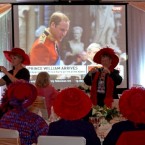 Two women take photographs while others watch the royal wedding celebrations on a big screen at a hotel early Friday, April 29, 2011 in Halifax, Nova Scotia. Over 300 people gathered at the hotel for the wedding party. (AP Photo/The Canadian Press, Mike Dembeck)