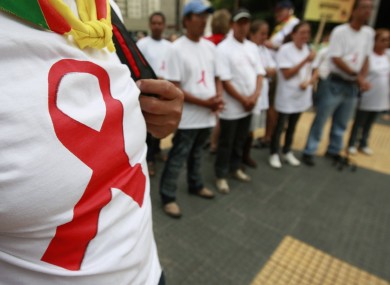People wears shirts with a red ribbon in a demonstration to celebrate the World AIDS Day at Republica square, in central Sao Paulo, Brazil last year.