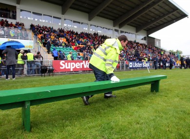 Who's that fella with the brolly and skinny jeans in the background as groundsman Michael Doherty dries the bench beore the Leitrim team arrive for the team photo.