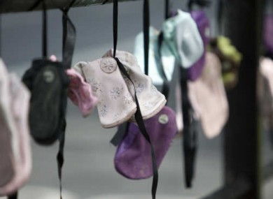 Children's shoes hung as a protest against clerical sexual abuse of children