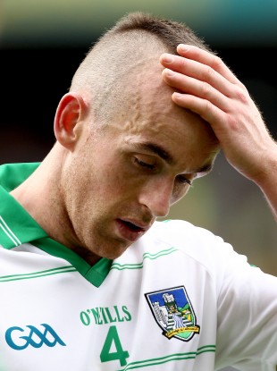 Steven Lavin feels his head, perhaps in disbelief, after Limerick's loss to Kerry.
