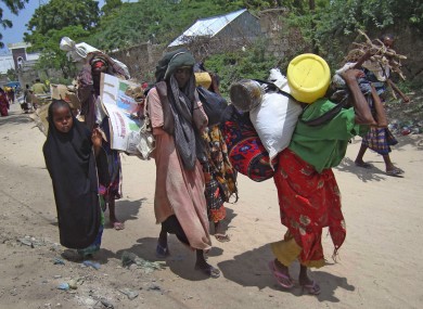 Somalis from southern Somalia carrying their belongings make their way to the refugee camp in Mogadishu