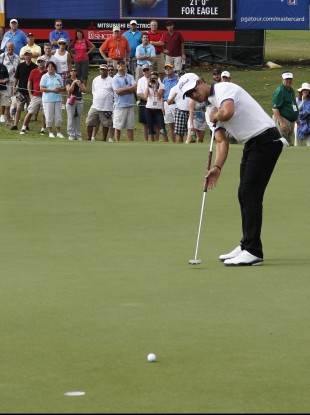 Scott watches his eagle putt attempt on the ninth green during the second round of the Tour Championship golf tournament at East Lake.