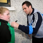 Ger Brennan signs autographs.