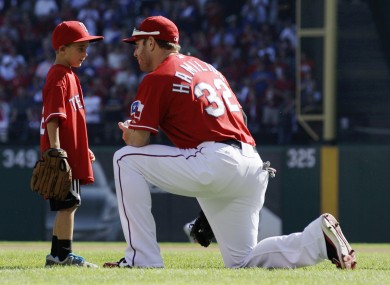 After throwing out a ceremonial first pitch, Cooper Stone, 6, talks with Texas Rangers left fielder Josh Hamilton.