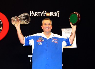 Phil Taylor celebrates with the trophy at Citywest last night.
