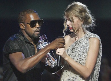 Kanye West takes the microphone from singer Taylor Swift as she accepts the