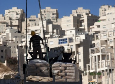 A construction worker working on a new housing unit in east Jerusalem today