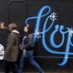 Members of the public pass by a mural in the Liberties area of Dublin as Finance Minister Michael Noonan prepared to announce the second half of Budget 2012 Photo: Julien Behal/PA Wire