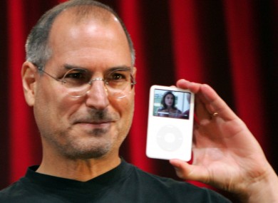 Jobs, pictured outside his home with an iPod