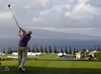 Stricker launches a tee shot down the hill at the 18th.