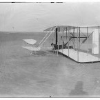 Wilbur Wright lying in a prone position in a damaged machine on the ground after an unsuccessful trial on 14 December, 1903. (Library of Congress, Prints & Photographs Division)