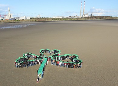 Undocumented migrants make a human shamrock on Sandymount strand in Dublin as part of the Justice for the Undocumented Campaign