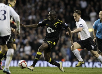 Fabrice Muamba controls the ball beside Tottenham Hotspur skipper Scott Parker.