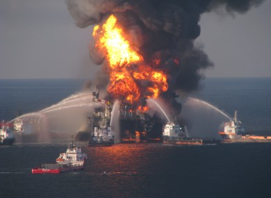 Firefighting ships attempt to put out the flames on the burning rig
