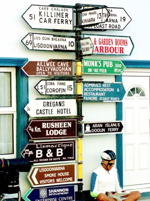 A cyclist studies his map at a junction in Ballyvaughn Co. Clare, Ireland in this May 22, 2002 file photo