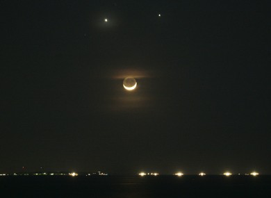 File photo of the planets Venus, top left, and Jupiter, top right, burning together in 2008