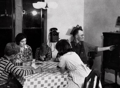 Happy families? Mom, dad and kids listen to the wireless in 1933.