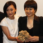 Angela Leong, right, wife of Macau tycoon Stanley Ho, holding the 1.5kg white truffle, celebrates with Mainland China's actress Zhou Xun after won the bid for US0,000 during an auction in 2007. (AP Photo/Ho Chon In)