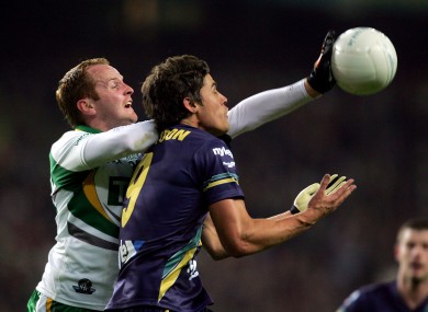 Coulter, left, challenges Garrick Ibbotson of Australia during the 2010 International Rules Series.