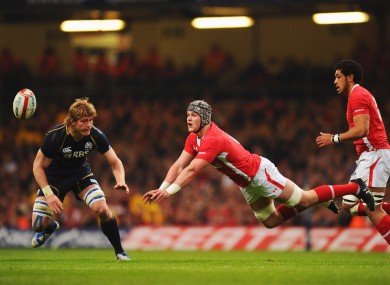 Dan Lydiate, centre, spreads the ball during his man-of-the-match performance against Scotland.