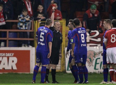 Rovers' Mark Quigley is shown a red card.