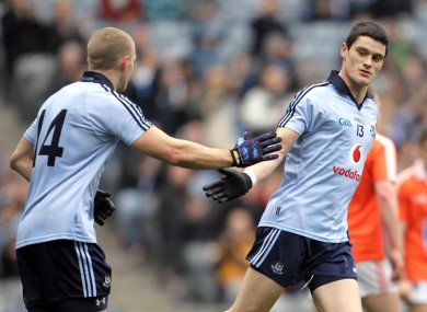 Eoghan O'Gara, left, celebrates the game's first goal with scorer Diarmuid Connolly.