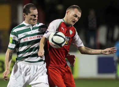 Cliftonville's Ciaran Caldwell and Rovers' Colin Hawkins compete for possession.
