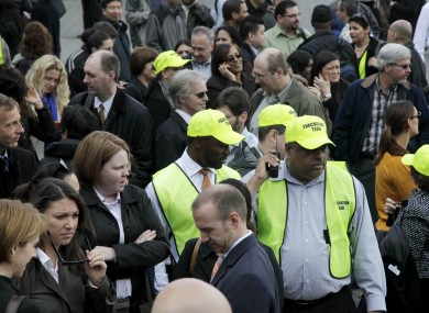 Members of the evacuation team stand among other office workers after 2 World Financial Center was briefly evacuated in New York.