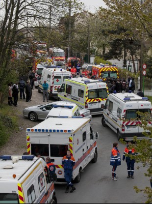 Emergency workers are seen around the area of a building accident, in Pierrefitte, north of Paris.