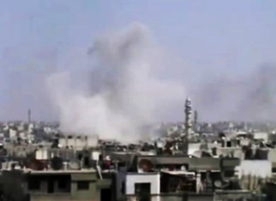 Smoke rises from Homs after what activists said was heavy shelling yesterday