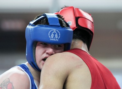 Joe Ward (blue) in action aganst Bahran Muzaffer (red) of Turkey. Ward lost 18-15.