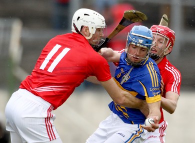 Cork's Pa Cronin and Lorcan McLoughlin bottle up James Woodlock of Tipperary