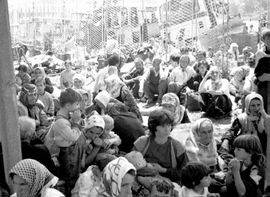 Some of the 30,000 predominantly Muslim refugees from the eastern Bosnian enclave of Srebrenica wait for transportation on 12 July 1995.