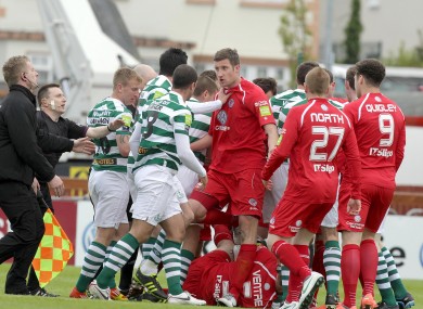 Security at the Showgrounds step in to separate the players after Chris Turner and Alan Keane's clash sparks a scuffle.