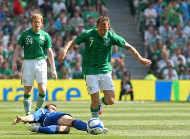 McGeady hurdles the challenge of Senad Lulic.