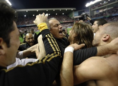 Real Madrid coach Jose Mourinho celebrates with his players after winning the title.