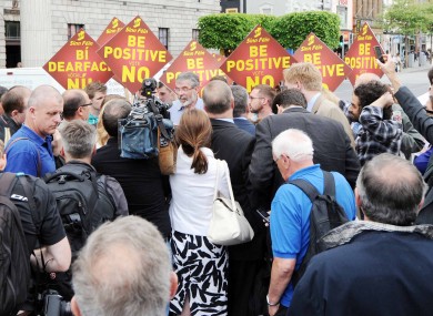 Scrum: Gerry Adams and other Sinn Féin party members speak to the media on O'Connell Street in Dublin this evening.