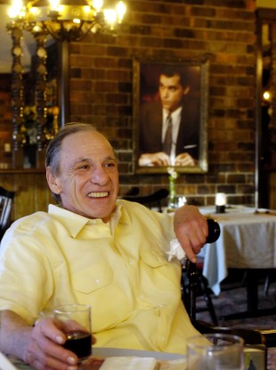 Henry Hill in Nebraska in 2005 with a picture of Ray Liotta, who played him in Goodfellas, in the background.