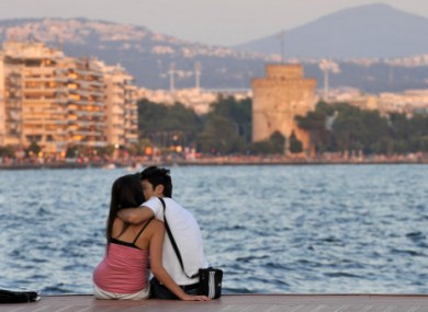 A couple kiss each other at the seaside of Thessaloniki a couple of days ahead of key elections.
