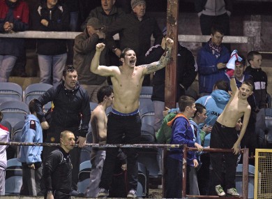 Local heroes: Drogheda fans roar on their side from the United Park terraces.