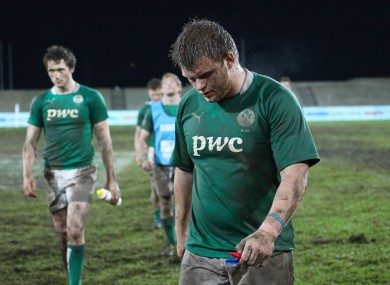 Dejected Irish players leave the field.