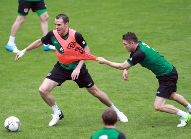 John O'Shea and Robbie Keane tussle in training today in Gdynia.